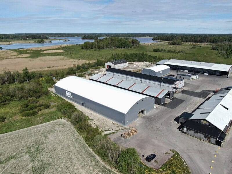 Grey fabric structure at EHL Prolist. Blue sky and the sea in the background. Photo taken with a drone at the facility in Möklinta.